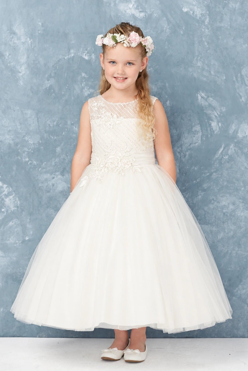 Full tulle skirt on an off-white flower girl dress.