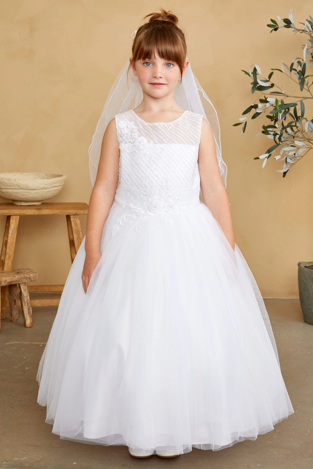 Visible on the white flower girl dress: a wide gathered hem.