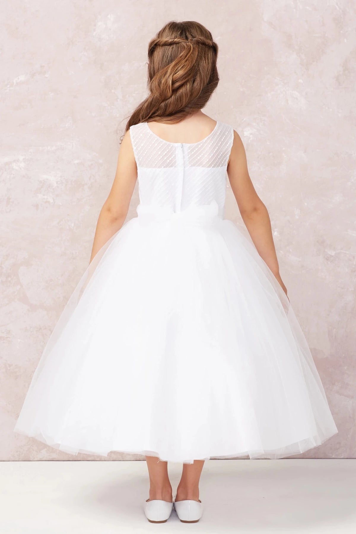 White flower girl dress featuring a satin back bow.