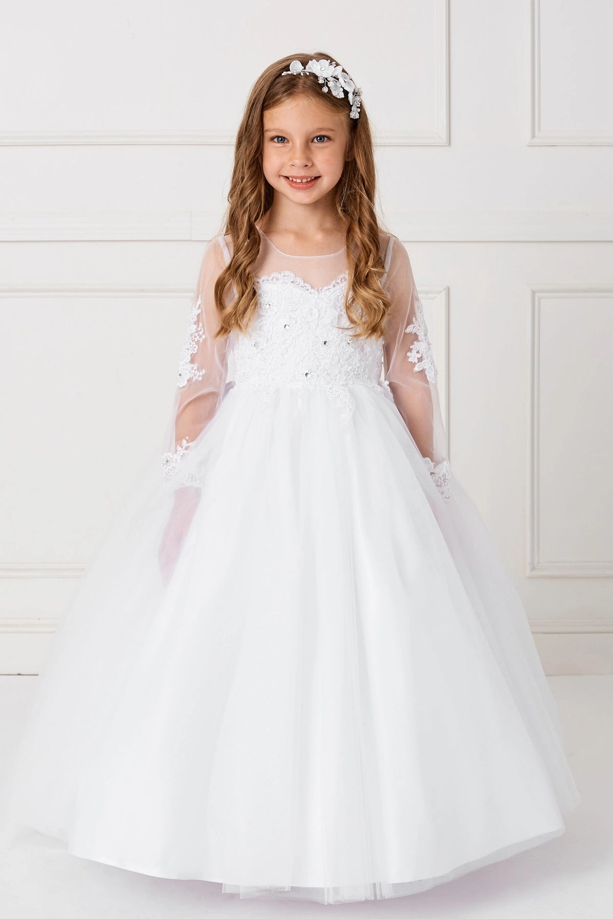 White kids pageant dress featuring floral lace and sheer long sleeves.
