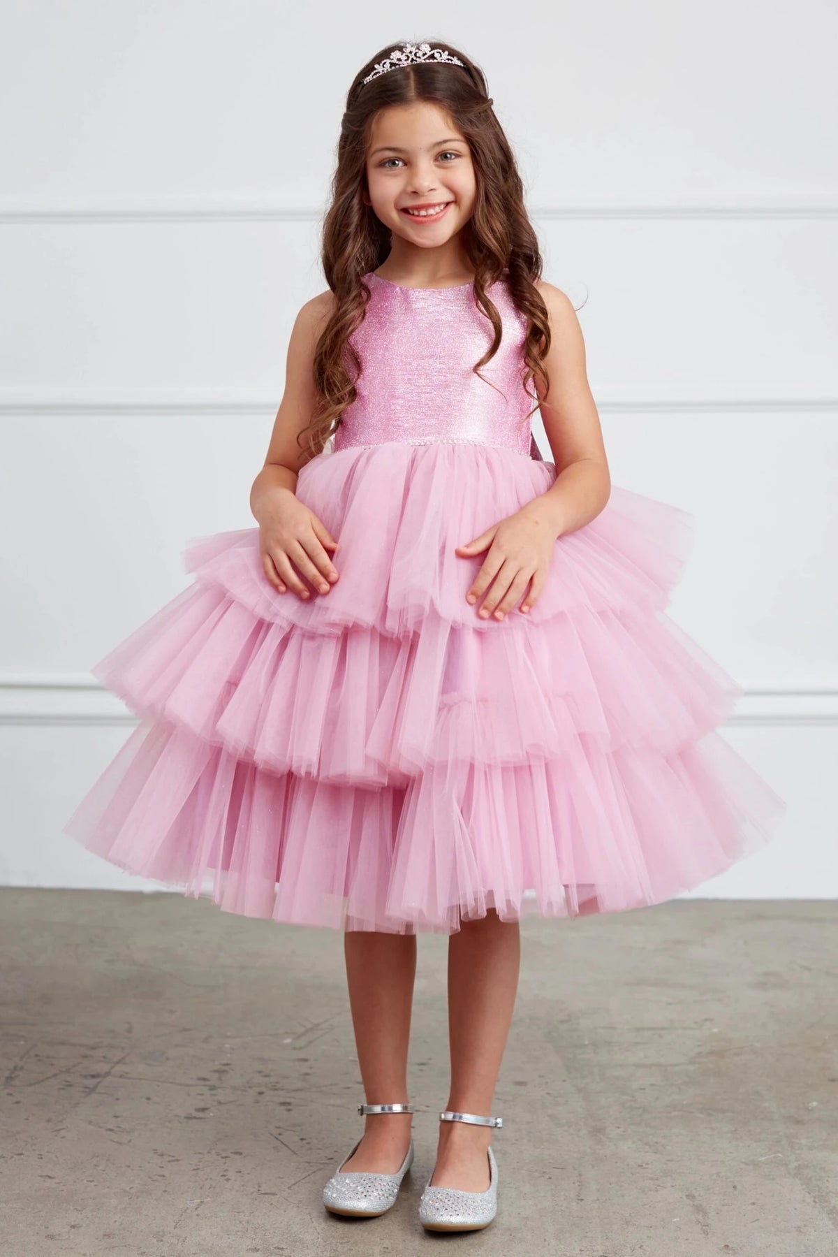 On this violet pink flower girl dress, tiered tulle ruffles are visible.