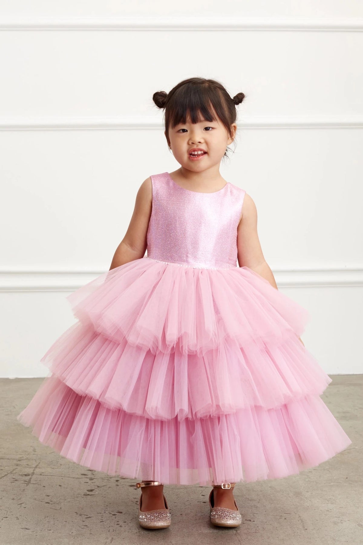 The violet pink flower girl dress features a sparkling sleeveless bodice.