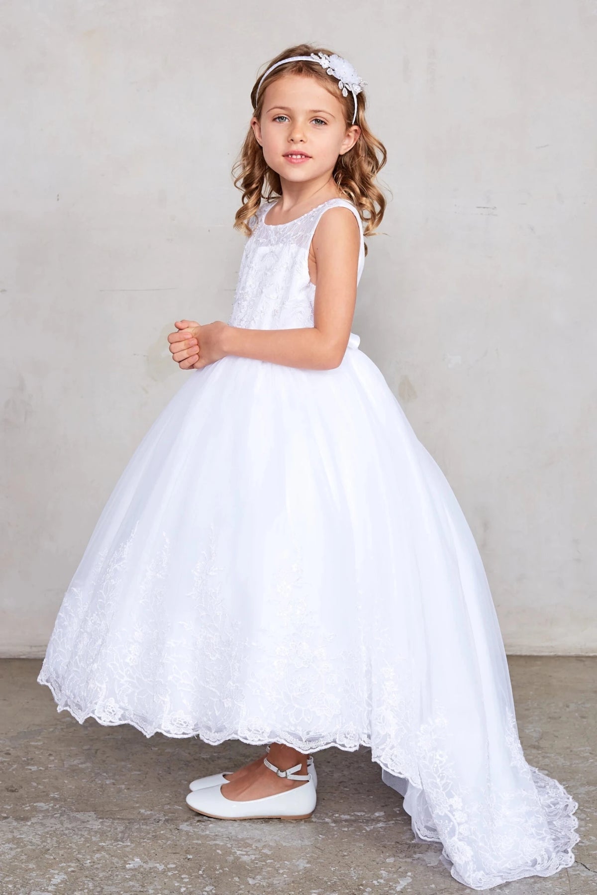High-low lace skirt is visible on the white flower girl dress.