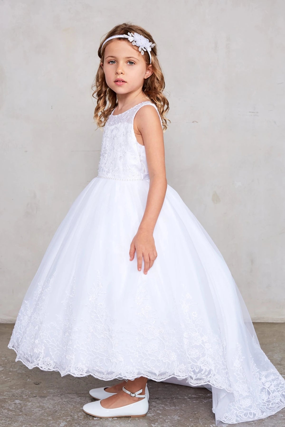 Featuring a full lace skirt, a white flower girl dress.
