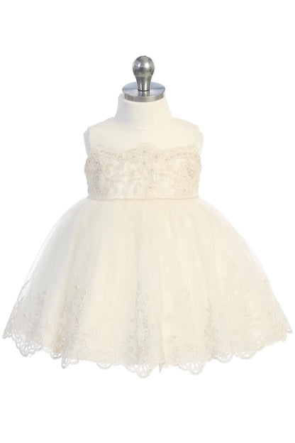 Scallops finish the champagne flower girl dress's full tulle skirt.