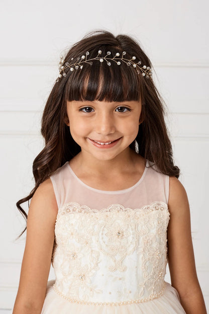 Over the sweetheart bodice, a champagne flower girl dress has a sheer yoke.