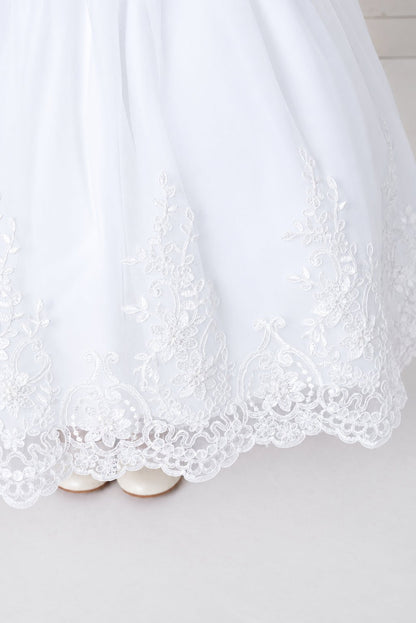 Looped lace scallops edge the white flower girl dress's hem.