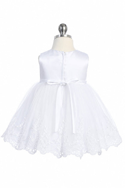 At the back waist, a white flower girl dress has a slim ribbon bow.