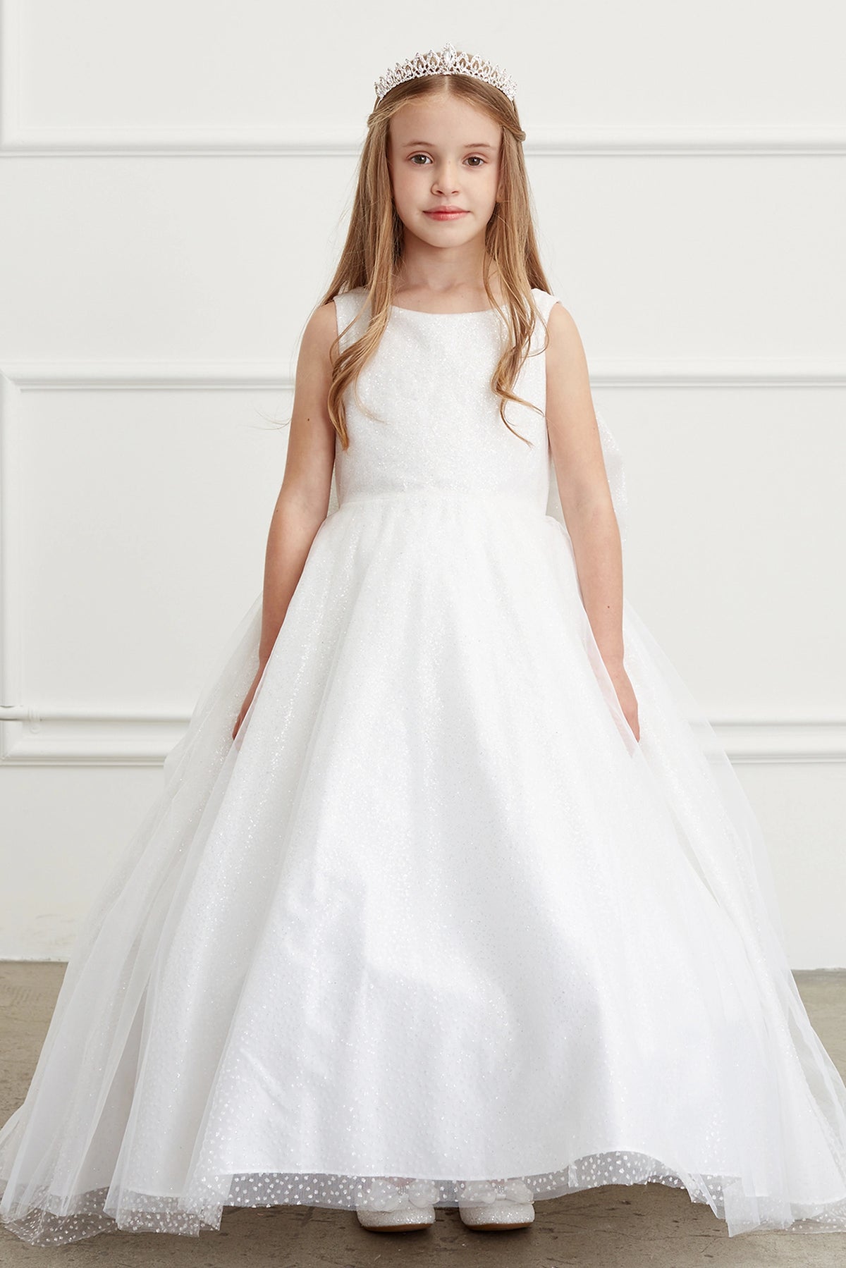White kids pageant dress featuring a full glitter skirt.