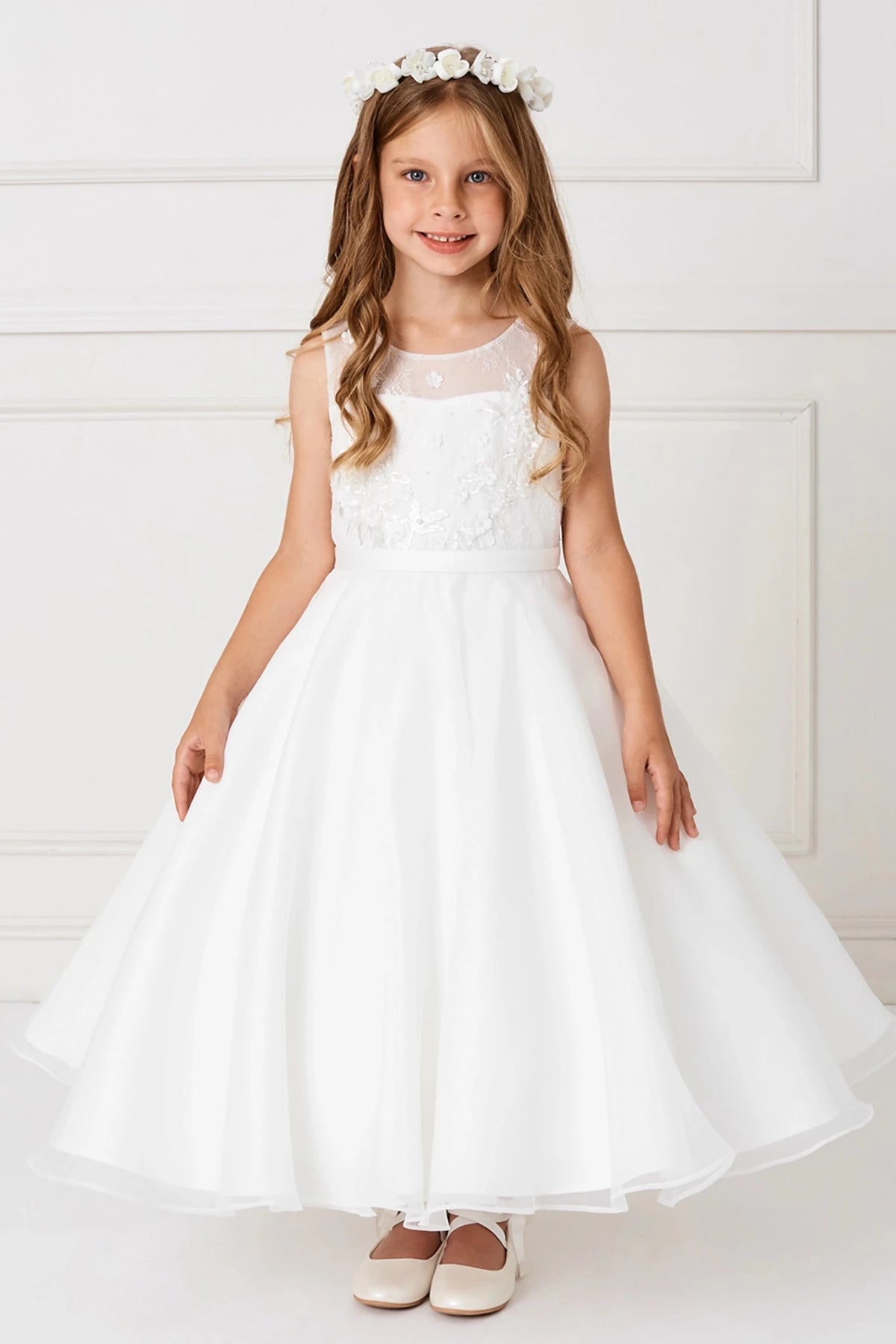 Focus on a flared satin skirt of the off-white flower girl dress.