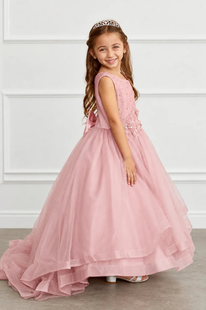 Mauve flower girl dress with a tiered hem sweeping into a train.