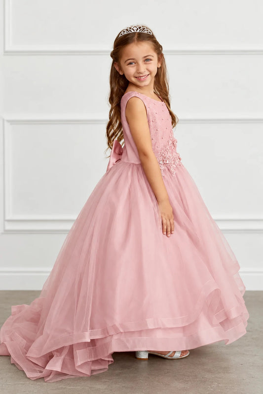 Mauve flower girl dress with a tiered hem sweeping into a train.