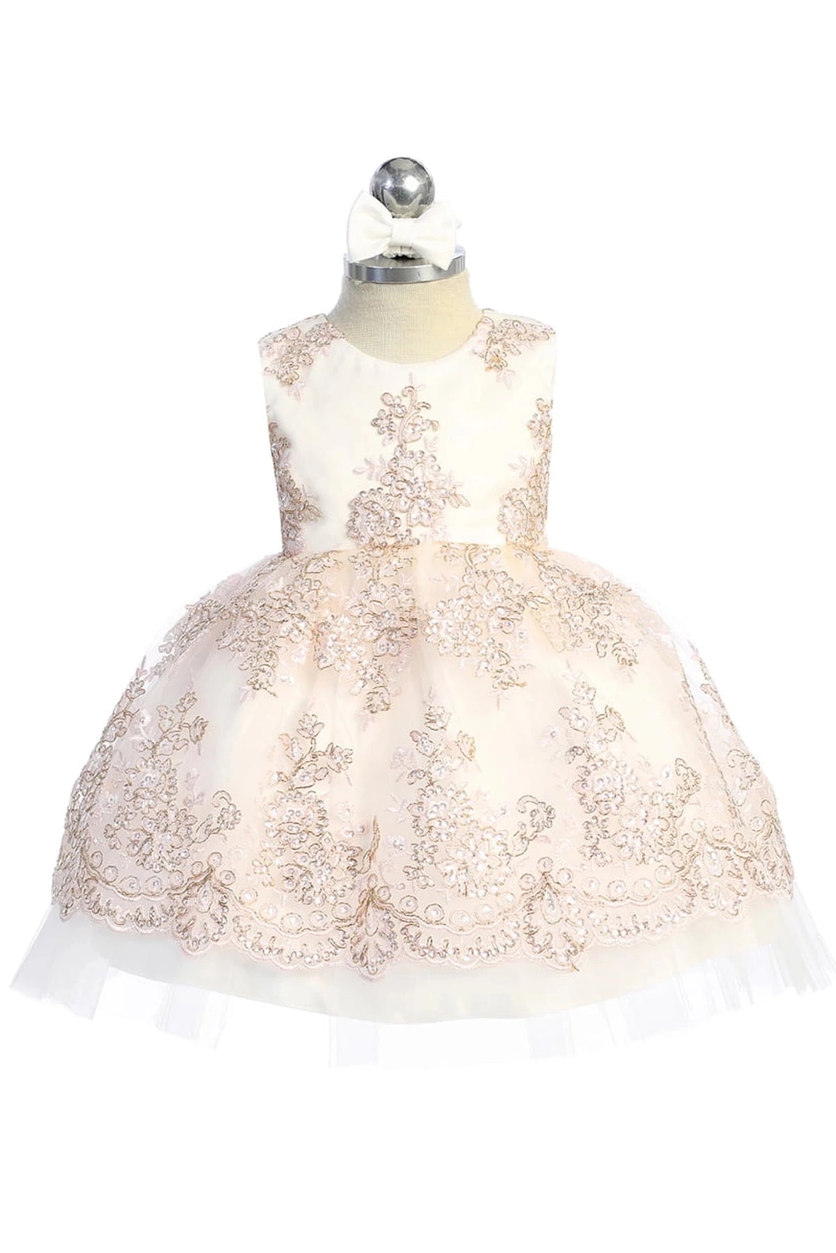 Embroidered floral overlay on a blush flower girl dress.