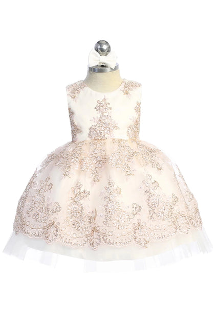 Embroidered floral overlay on a blush flower girl dress.