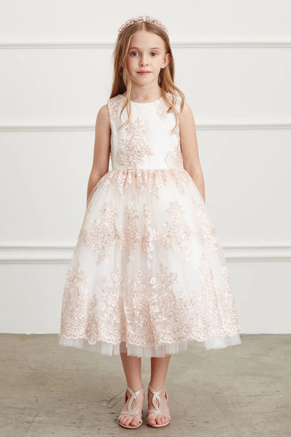 Shown here, a blush flower girl dress with a scalloped overlay hem.