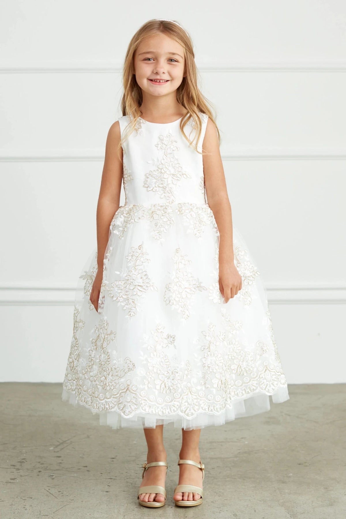 With gold floral embroidery, an off-white flower girl dress.