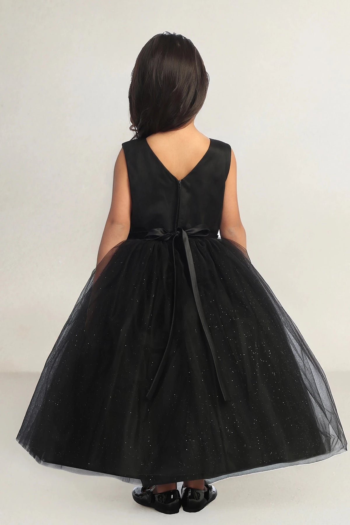 This black flower girl dress displays V-shaped back.