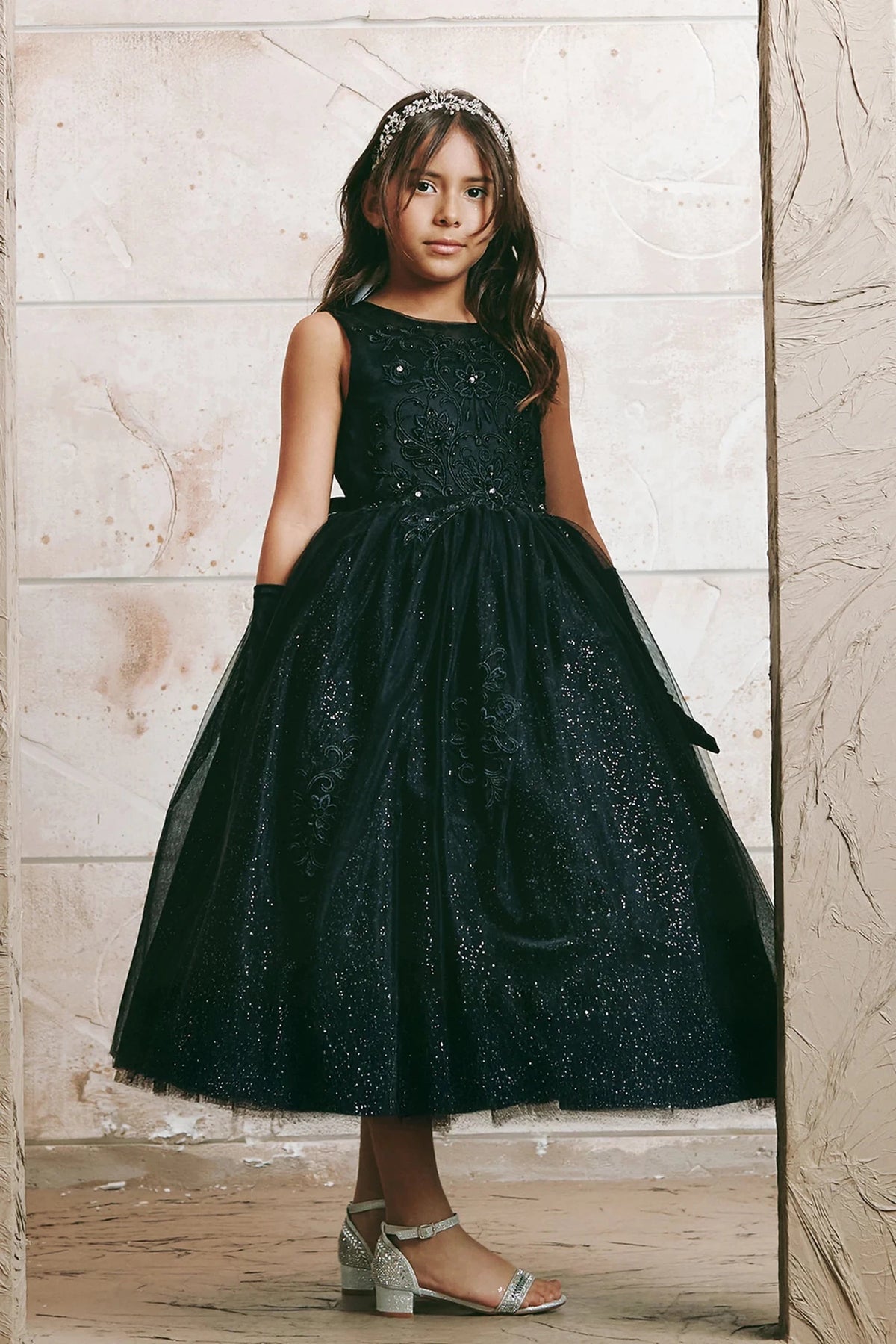 Glittered mesh skirt: detail of the black flower girl dress.