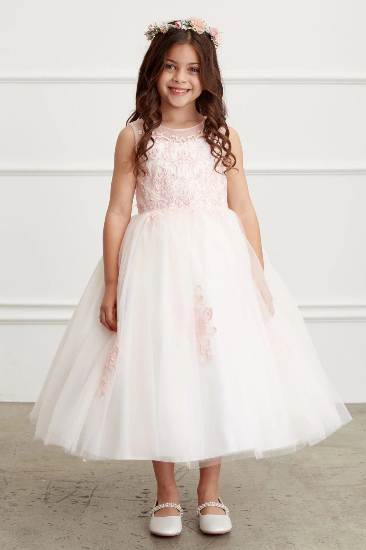 3D flower waist accents the blush flower girl dress.