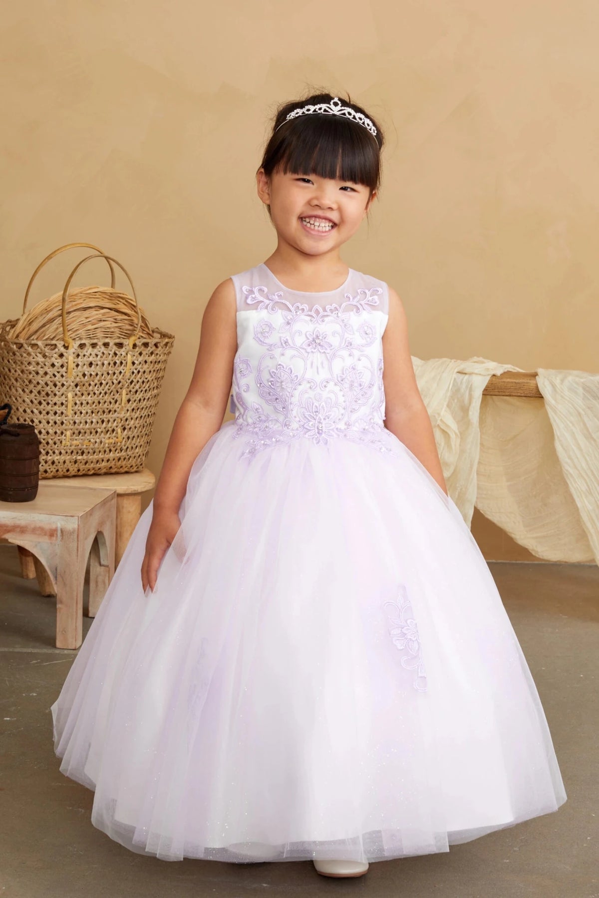 Emphasis on a floral lace bodice of the lilac flower girl dress.