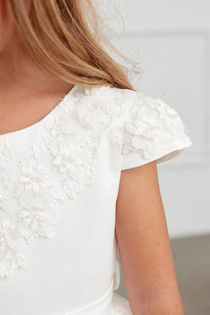3D shoulder flowers on an off-white flower girl dress.
