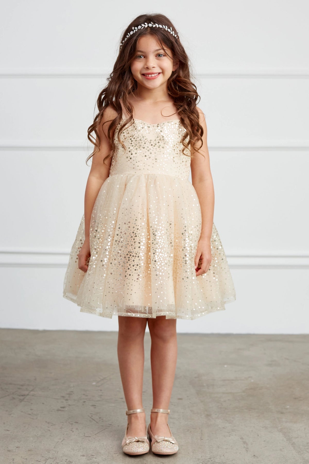 Gold kids pageant dress featuring sequins across the bodice and skirt.