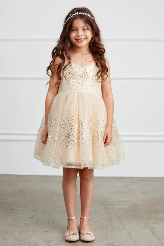 This gold flower girl dress displays scattered metallic dots.