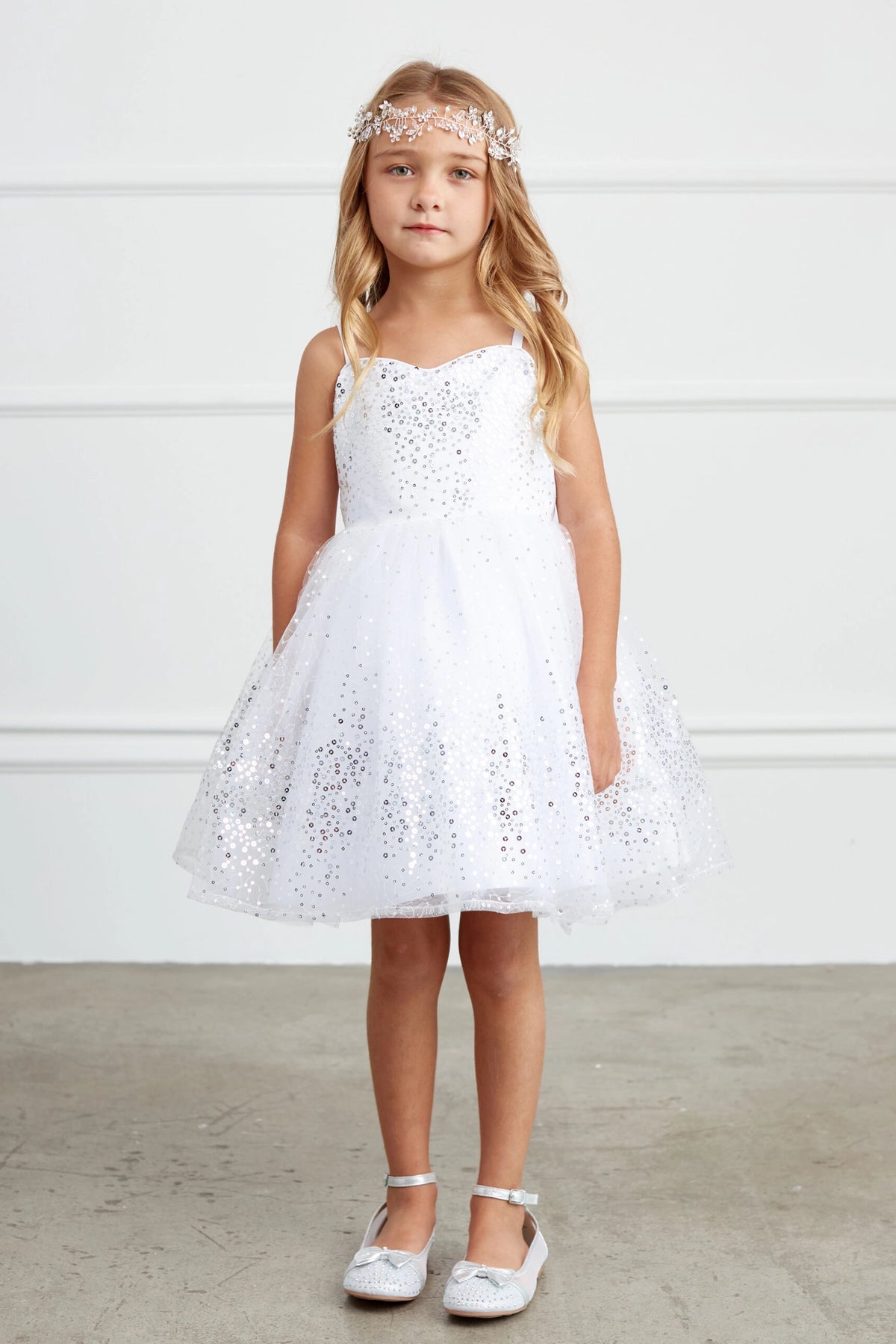 Silver kids pageant dress featuring sequins across the bodice and skirt.