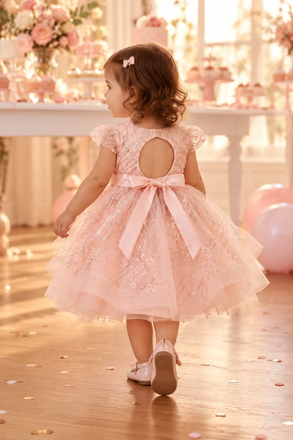 Back view of the rose gold baby and toddler dress with a keyhole opening and tied waist bow.