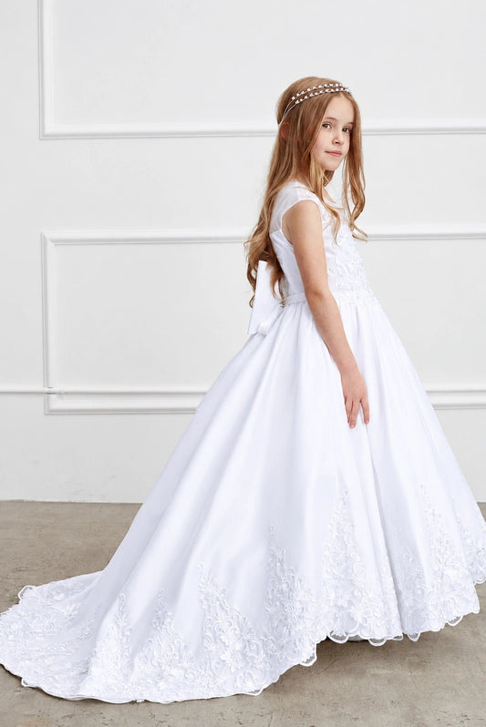 Wide floral lace follows the white flower girl dress's flowing hem.