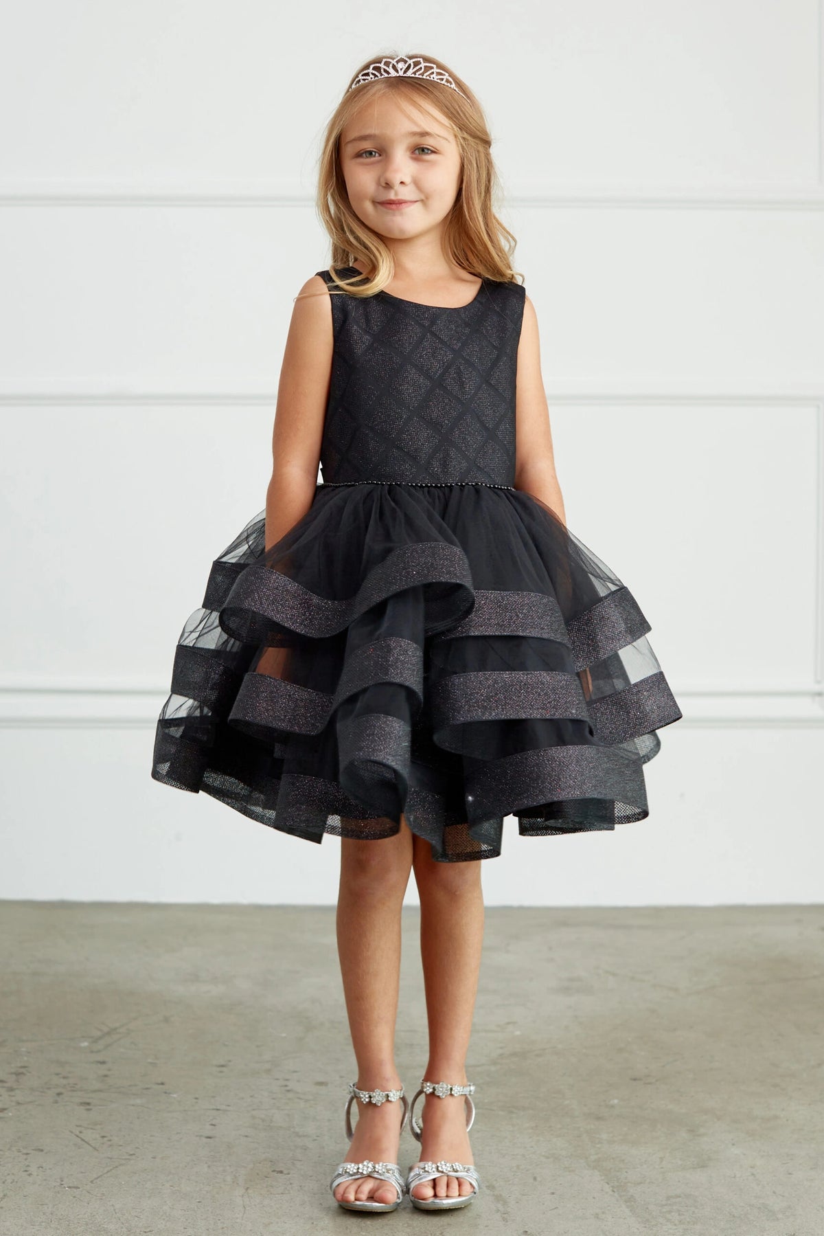 Black kids pageant dress featuring a short tiered mesh skirt.