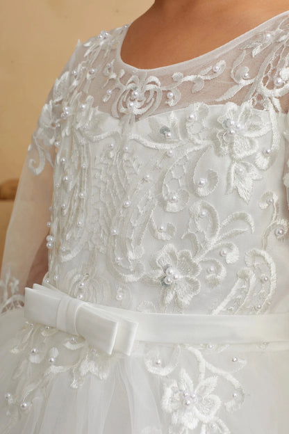 Close-up of the ivory illusion lace with sheer sleeves flower girl dress.