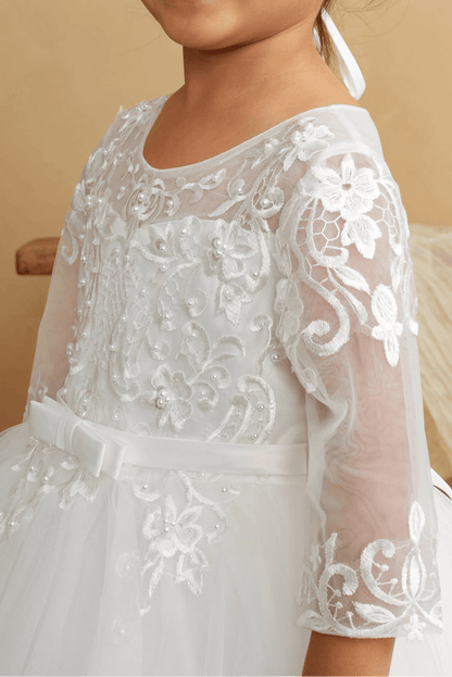Close-up of the ivory illusion lace with sheer sleeves flower girl dress.