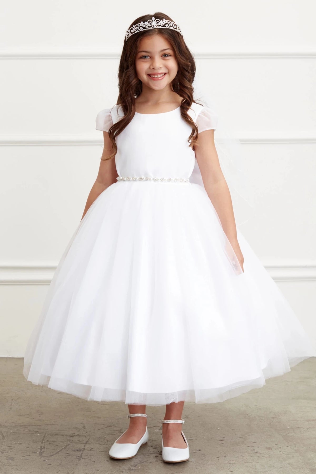 Small satin sleeves accent the white flower girl dress.