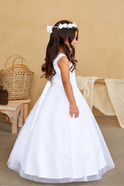 From the side, the white flower girl dress shows a wide tulle skirt.