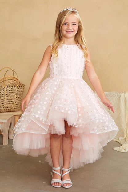 With a short layered front skirt, a blush flower girl dress.
