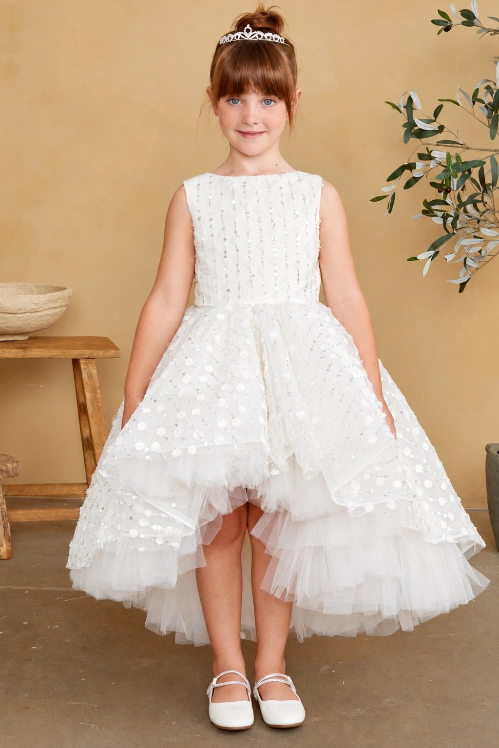 Featuring a 3D dotted skirt overlay, an off-white flower girl dress.