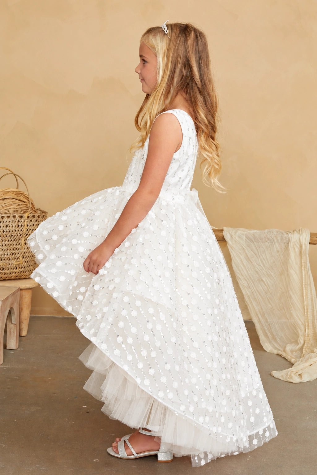 Long tulle back train is visible on the off-white flower girl dress.