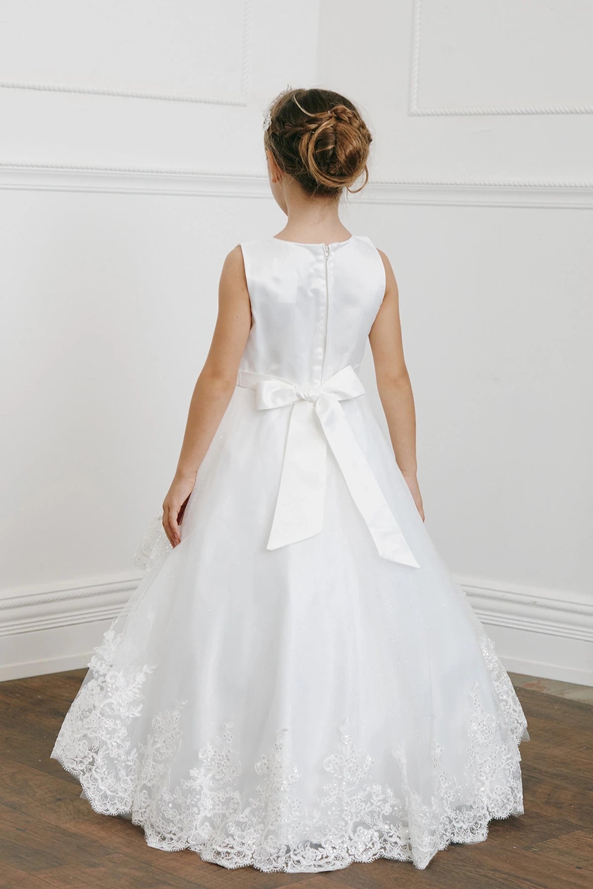 Back view of the ivory sequin lace with a tulle peplum flower girl dress.