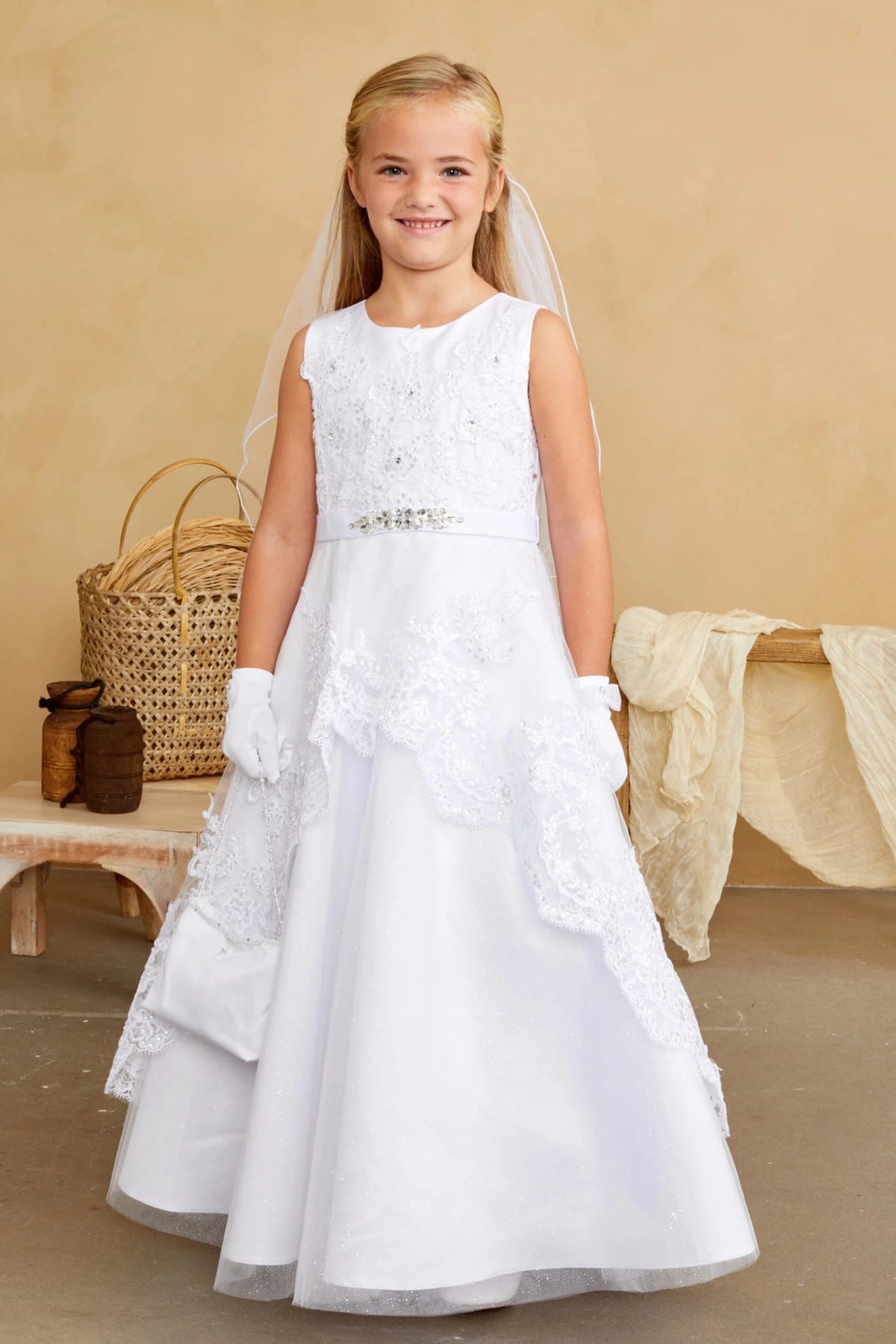 On this white flower girl dress, a jeweled waistband is visible.
