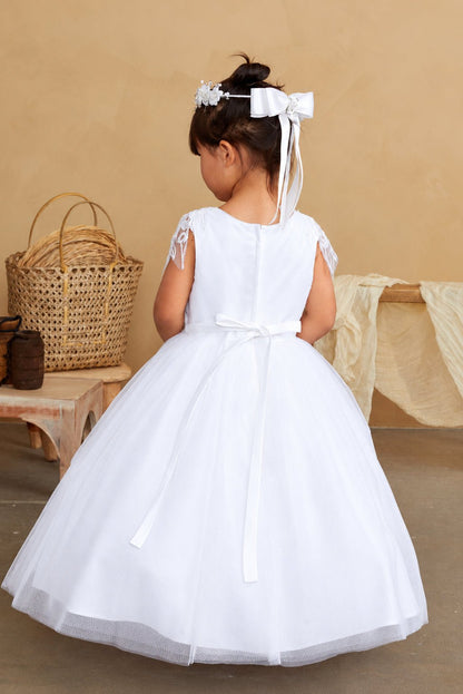 Long satin tails hang from the white flower girl dress's back bow.