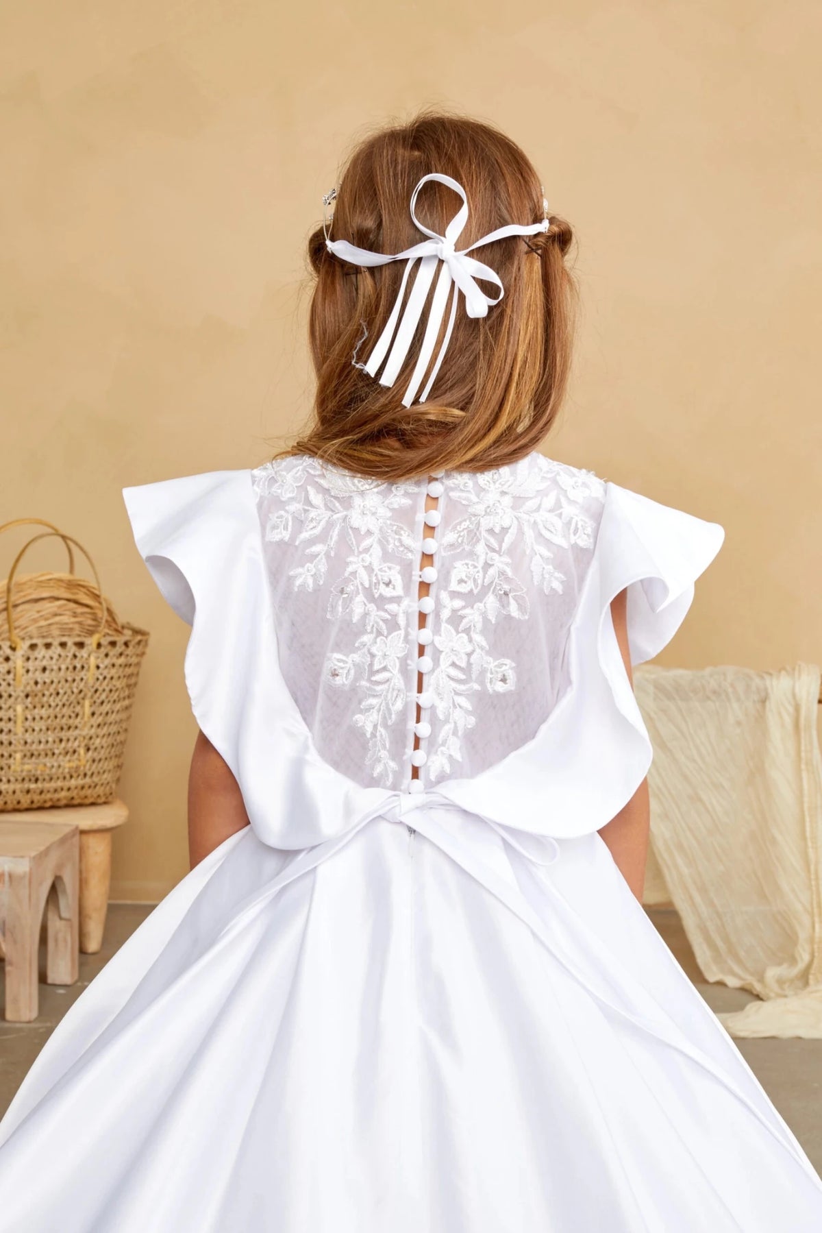 White flower girl dress, showing embroidered button back.