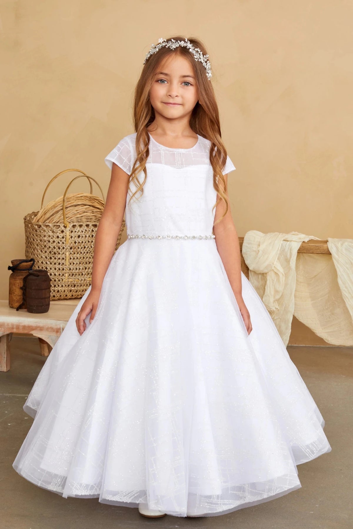 A view of beaded waist trim on the white flower girl dress.