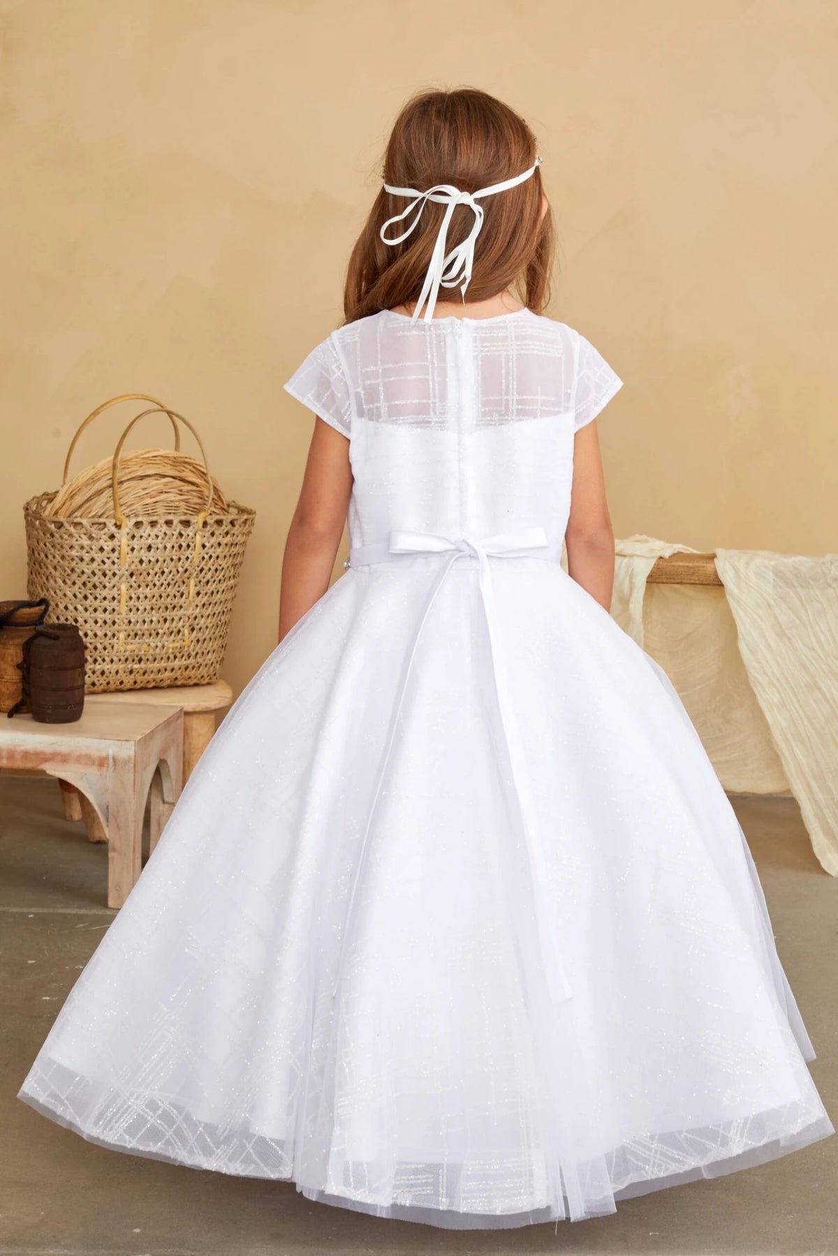 White flower girl dress featuring a satin back sash.