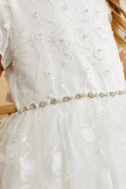 Close-up of the ivory 3d floral lace with pearls and sequins flower girl dress.
