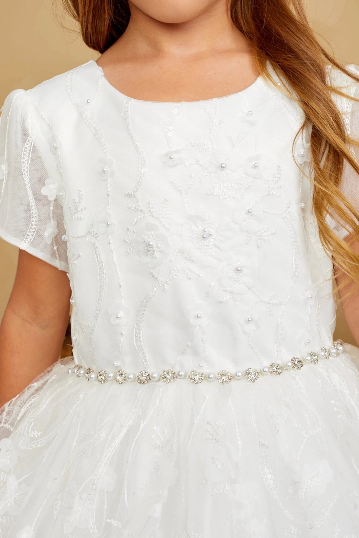 Close-up of the ivory 3d floral lace with pearls and sequins flower girl dress.