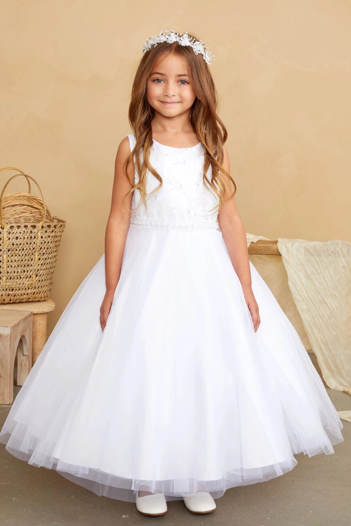Defined by a beaded sleeveless bodice, this white flower girl dress.