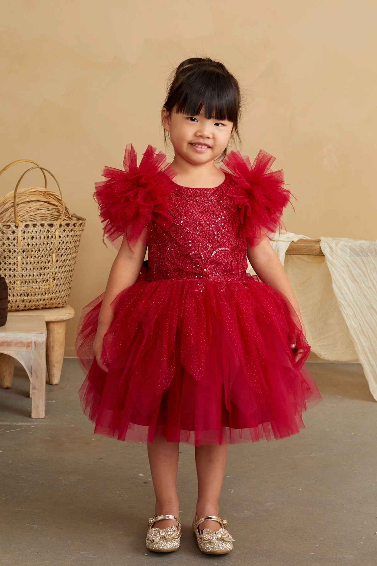 Red kids pageant dress featuring feather-trimmed flutter sleeves.