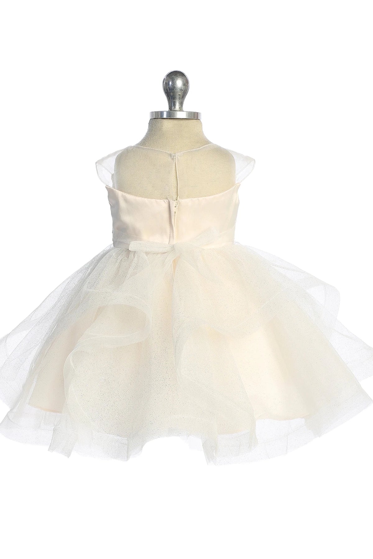 Satin bow ties above the champagne flower girl dress's folded tulle skirt.