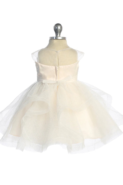 Satin bow ties above the champagne flower girl dress's folded tulle skirt.